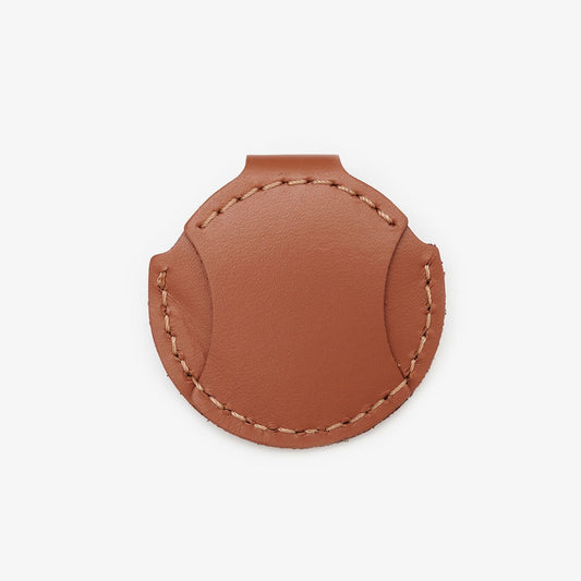 Brown leather AirTag holder for cats with gold button, handmade from Italian leather on a white background