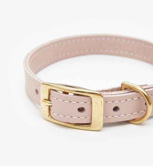 Closeup view of a luxury pink leather dog collar with premium stitching and elegant design