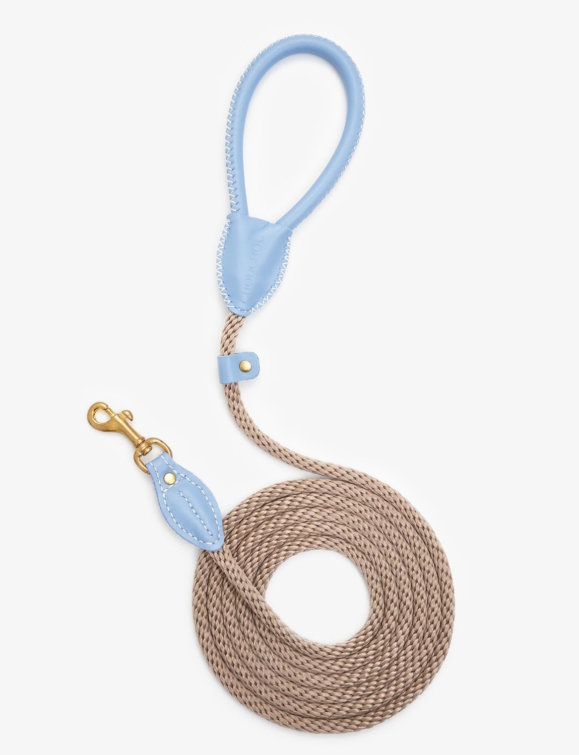 Closeup view of a luxury rope dog leash made from light blue leather with brass hardware