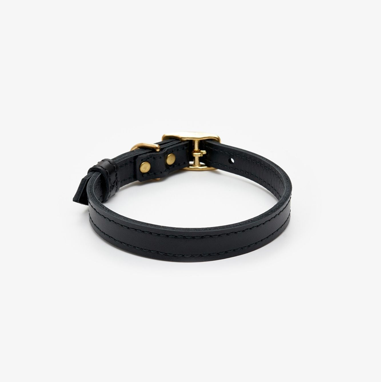 Side view of a premium black leather dog collar featuring a gold buckle for a touch of elegance