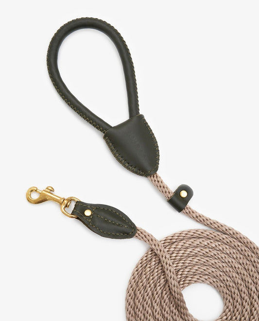 Coiled view of a premium rope dog leash with olive leather accents and elegant brass hook