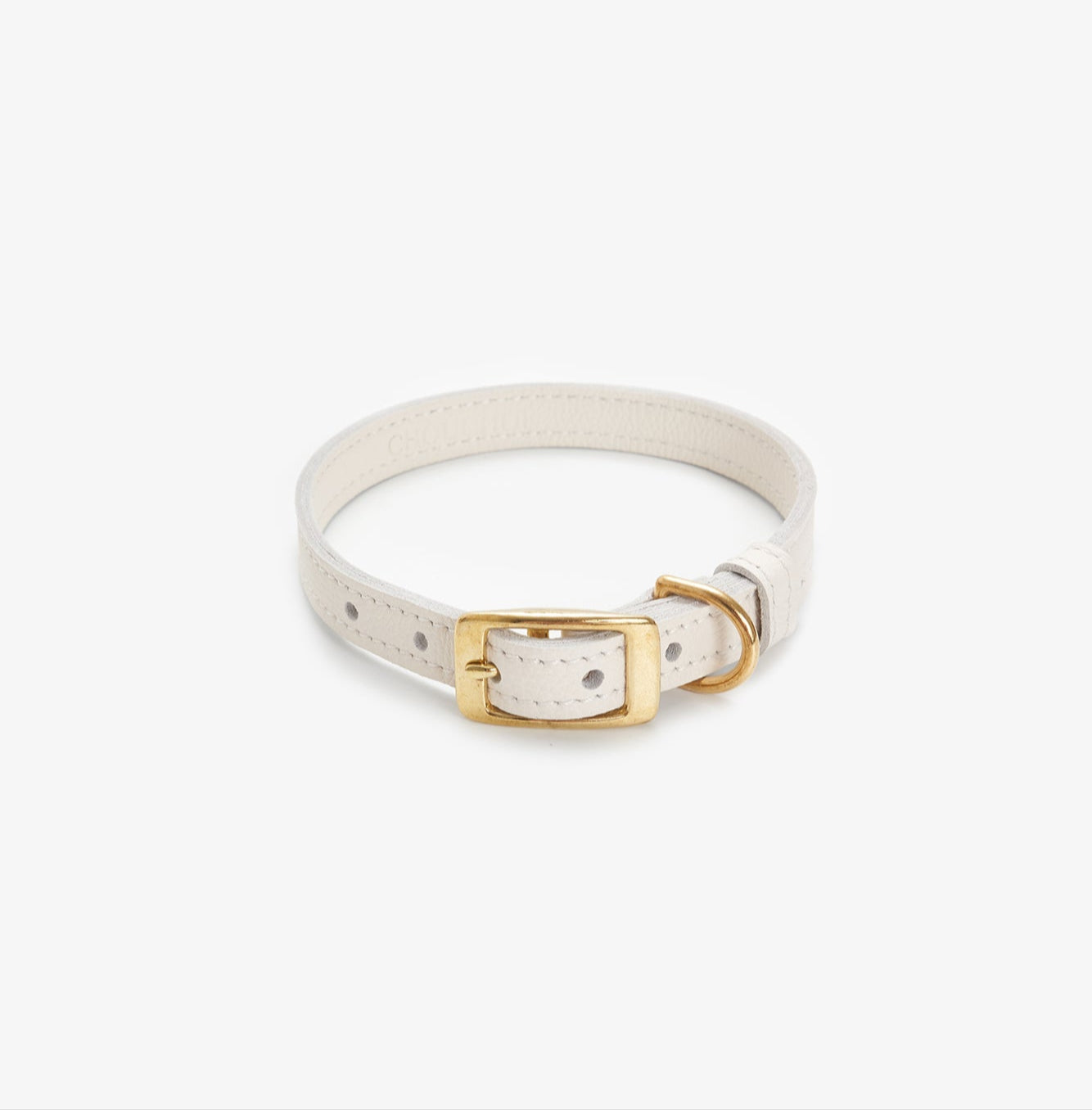 Side view of a premium milk leather dog collar featuring a gold buckle for a touch of elegance