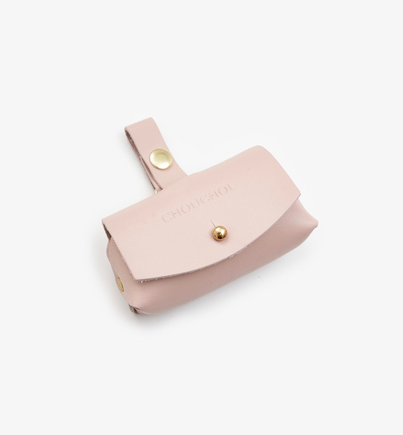Pink dog waste bag dispenser with gold hardware on a white background
