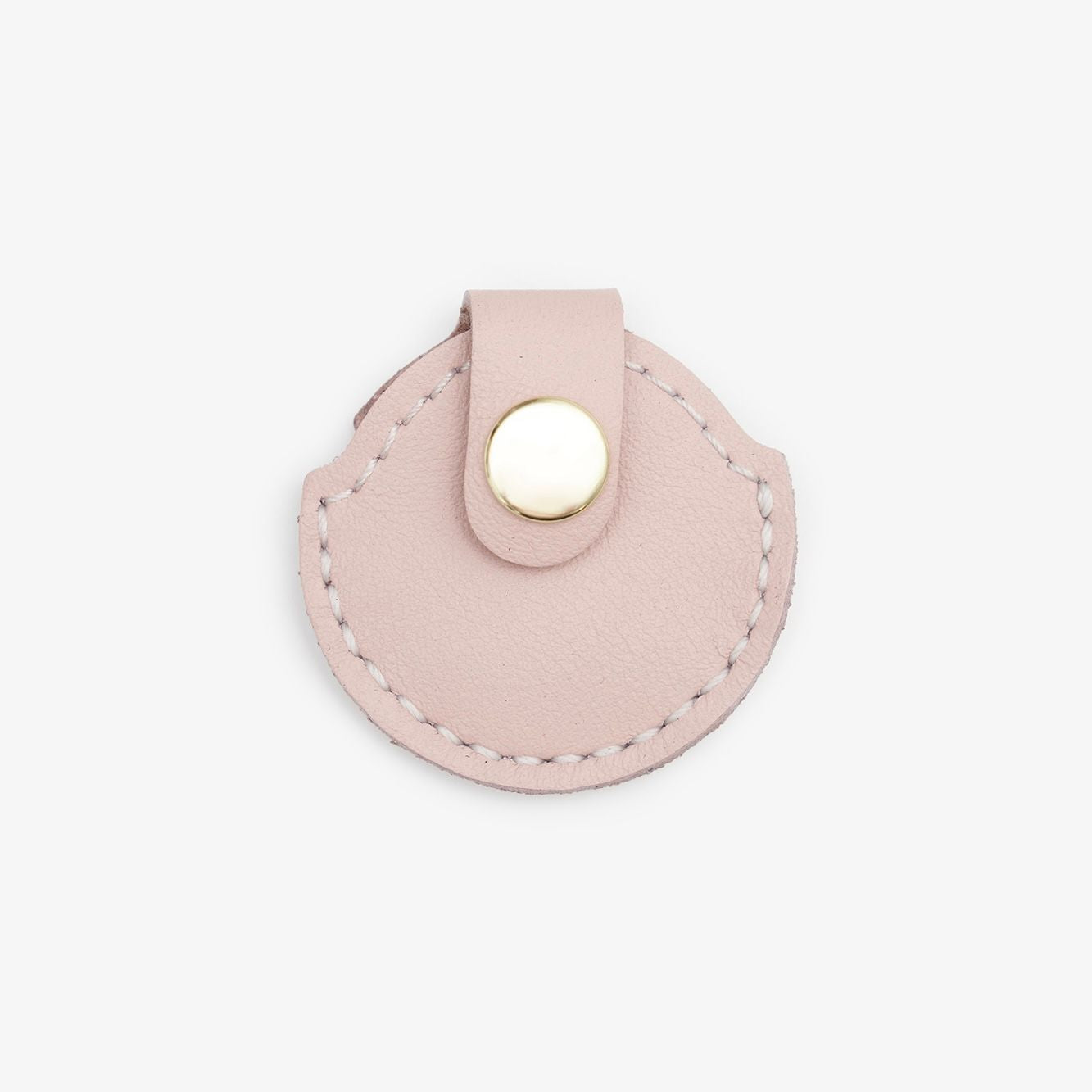 Pink leather AirTag holder with gold button on a white background