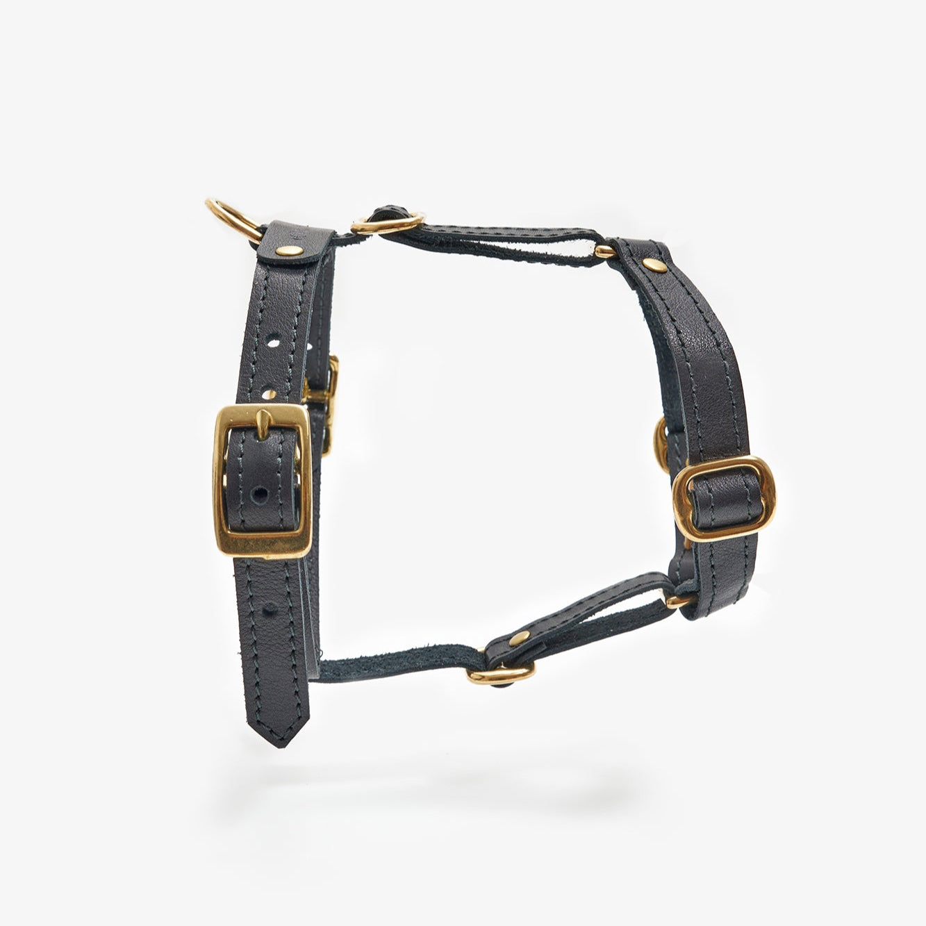 Side view of a designer black leather dog harness featuring sleek lines, durable hardware, and a minimalist design