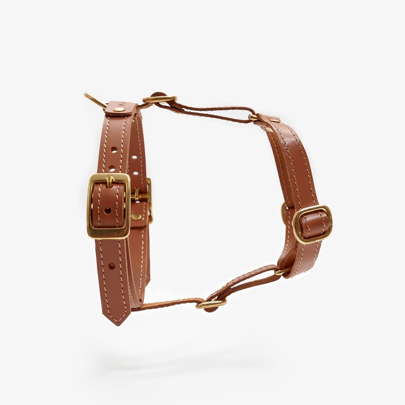 Side view of a designer brown leather dog harness featuring sleek lines, durable hardware, and a minimalist design