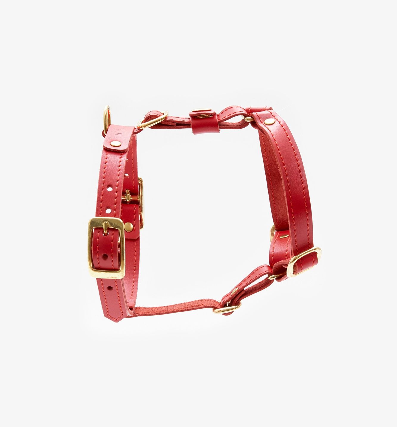 Side view of a designer red leather dog harness featuring sleek lines, durable hardware, and a minimalist design