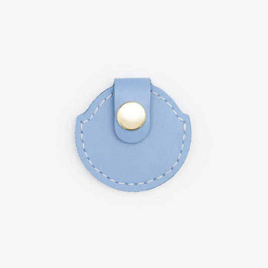 Light-Blue leather AirTag holder with gold button, handmade from Italian leather on a white background