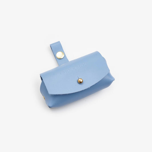 Light-Blue Italian leather dog waste bag dispenser with gold hardware on a white background