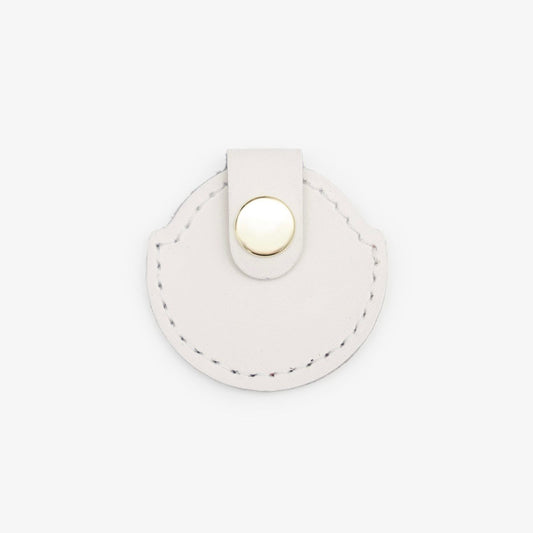 Milk-White leather AirTag holder with gold button, handmade from Italian leather on a white background