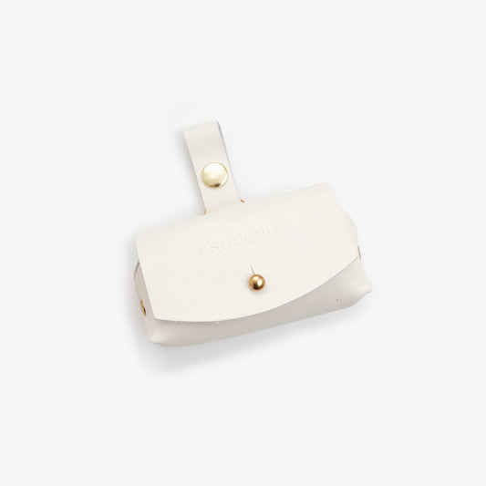milk-white Italian leather dog waste bag dispenser with gold hardware on a white background