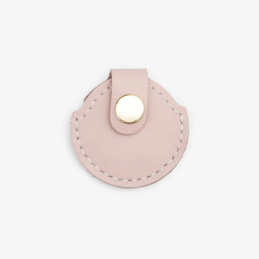 Pink leather AirTag holder with gold button, handmade from Italian leather on a white background