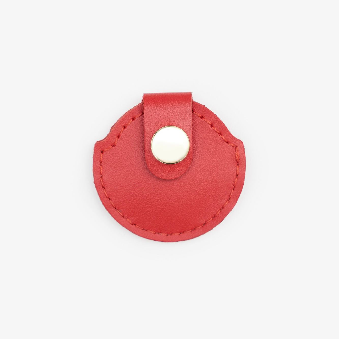 Red leather AirTag holder with gold button, handmade from Italian leather on a white background