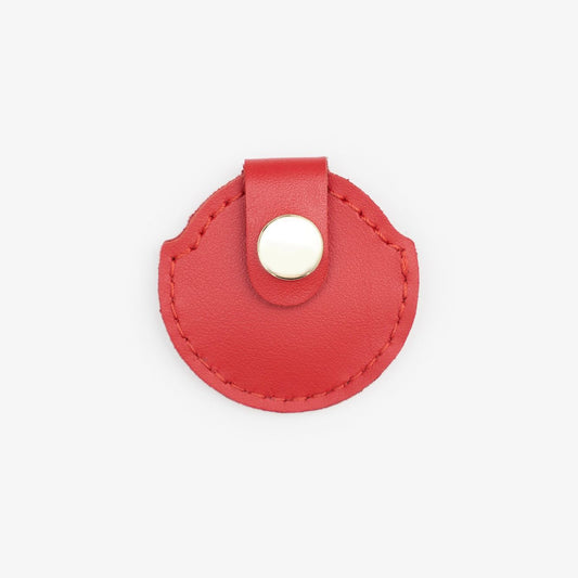 Red leather AirTag holder with gold button, handmade from Italian leather on a white background